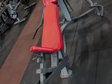 a red bench in the middle of a gym