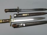 four different types of knives are displayed on a table