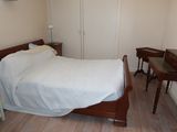 a bed that is in a small room with a desk