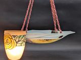 a surfboard hanging from a rope with a light on it