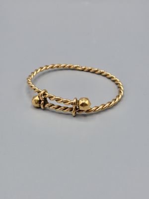 une photo d'un bracelet en or orné de deux petites perles