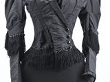 an image of a black jacket with fringes on a mannequin