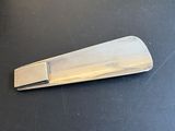 a silver tie clip on a black table