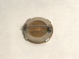 a small metal object on a white surface