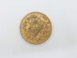 a close up of a gold coin on a white surface