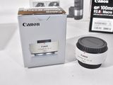 a camera lens sitting next to a box on a table