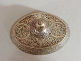 an image of a silver box sitting on top of a white table