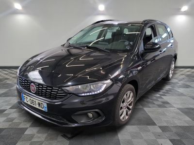 the black car is parked on a checkered floor in the garage