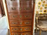 a wooden dresser with a mirror on top of it