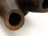 a close up of a metal pipe on a white surface