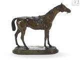 statue of a horse standing on a base on a white surface