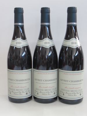 three bottles of wine sitting on top of a white table