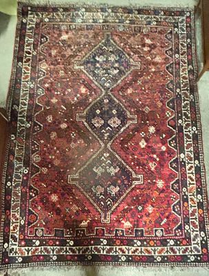 rug on the floor in the corner of a room with a cat on the floor