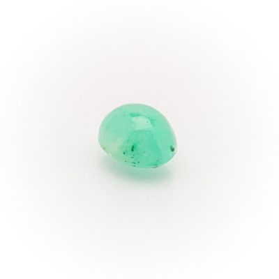 a close up of a green stone on a white surface