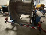 an image of a large wooden cable reel in a warehouse