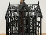 a small metal structure with a wooden structure on top of it