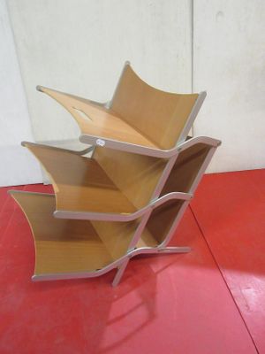 a stack of books on a red floor with a white wall