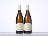 two bottles of wine sitting on top of a table next to each other