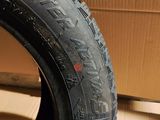 a close up of a tire on a cardboard box with a cardboard box in the background