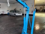 a blue crane that is sitting in a garage