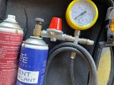 a canister of gas and a canister of hoses in a case