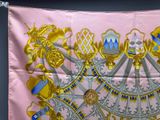 an image of a pink silk scarf with gold and blue designs