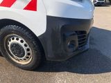 a white van with red stripes parked in a parking lot