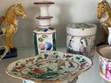 a glass shelf with a lot of decorative items on it