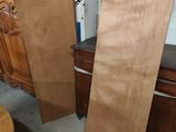two pieces of wood sitting on the floor next to each other