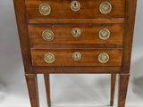 an antique wooden chest of drawers with marble top