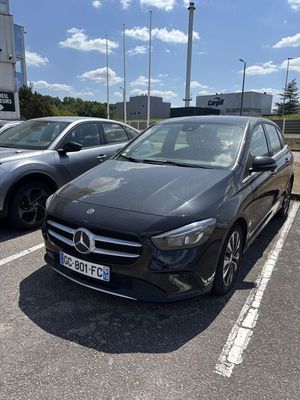 two cars parked in a parking lot next to each other