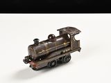 un petit train sur une surface blanche avec un fond noir