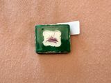 a picture of a green and white tile with a picture of a bird on it
