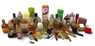 many different types of perfumes and bottles on a white surface