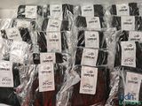 many bags of luggage sitting on a shelf in a store