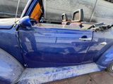 a blue car that is parked on the side of the street