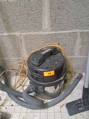 a dust collector sitting on the floor next to a wall