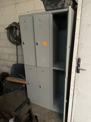 two lockers and a chair in a garage