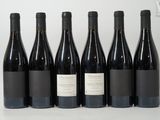 six bottles of wine are lined up in a row