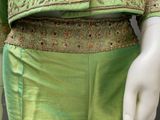 an image of a mannequin wearing a green and gold dress