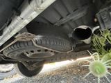 a close up of a car ' s exhaust pipe and exhaust muffler