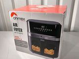 an open box of an air fryer sitting on a table