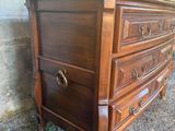 a wooden dresser with a mirror on top of it