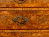 a wooden chest of drawers with brass handles on it