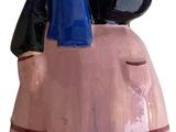 a figurine of a man sitting on top of a pink car
