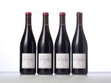 three bottles of wine are lined up on a table
