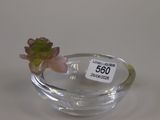 a small glass bowl with a small flower in it