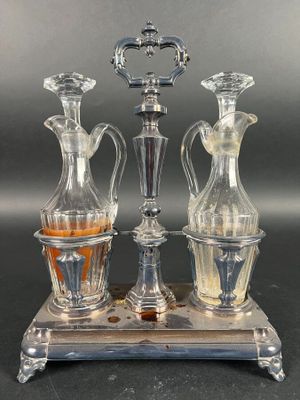 three glass vases sitting on a metal stand