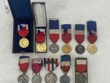 a lot of medals that are sitting on a table
