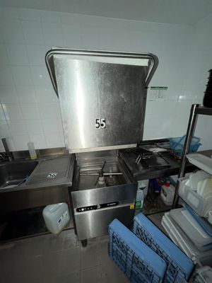 a kitchen with a stove, sink, and shelves in it